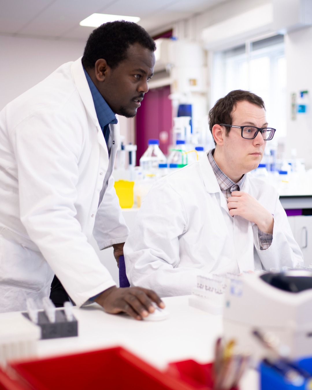 Two Cansford scientists in the lab looking at results.
